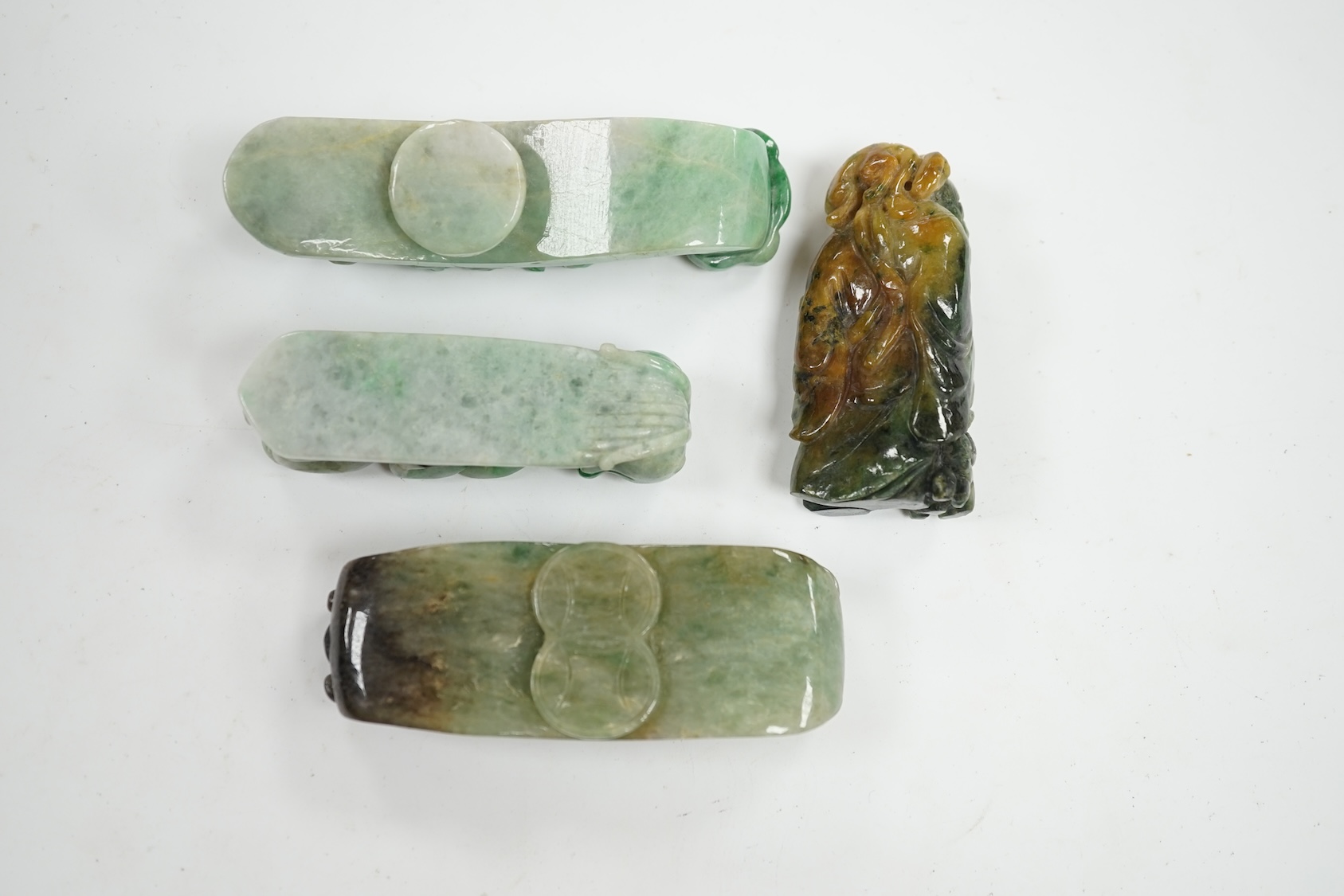 Four Chinese green bowenite jade carvings and belt hooks, largest 9.5cm in length. Condition - good